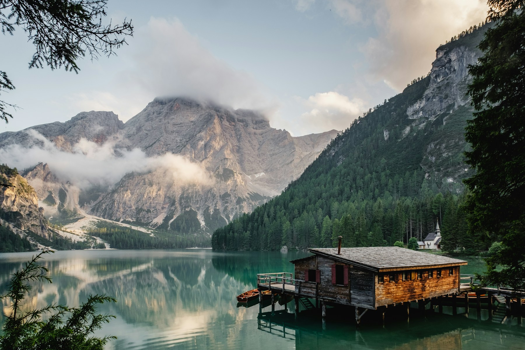 Still blue lake surrounded by green mountains